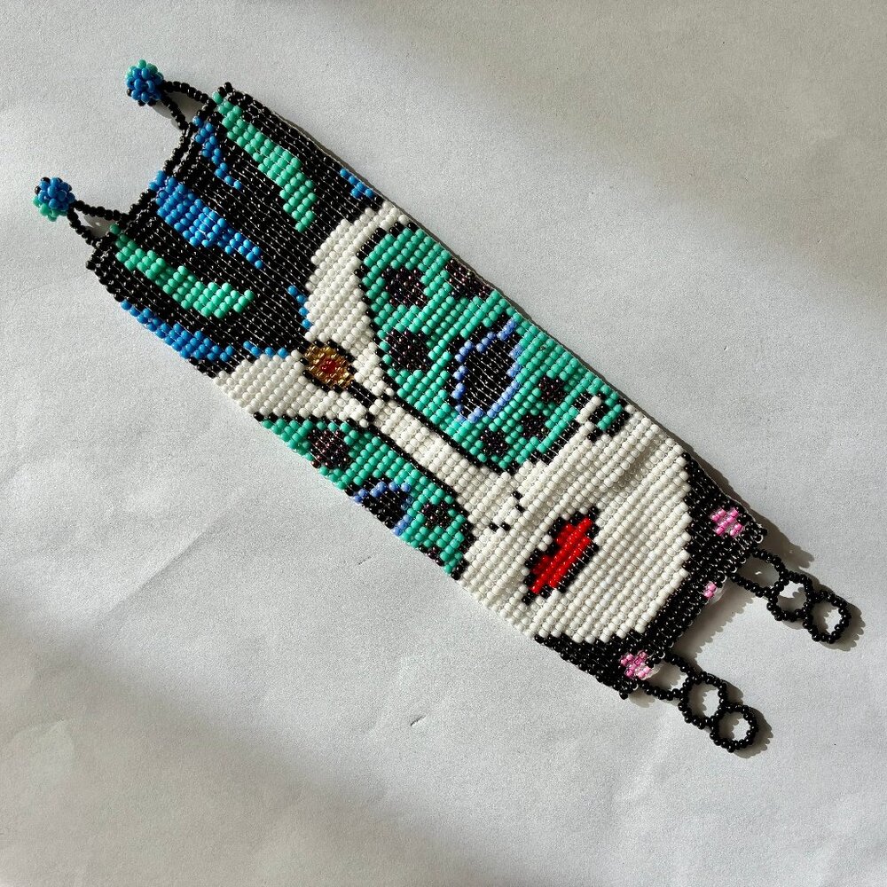 Seed Bead Woven Bracelet Featuring a Masked-Women